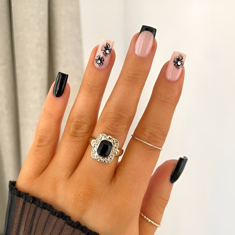 Glossy black Halloween nails with spider web details – creepy crawly nail art for spooky season.