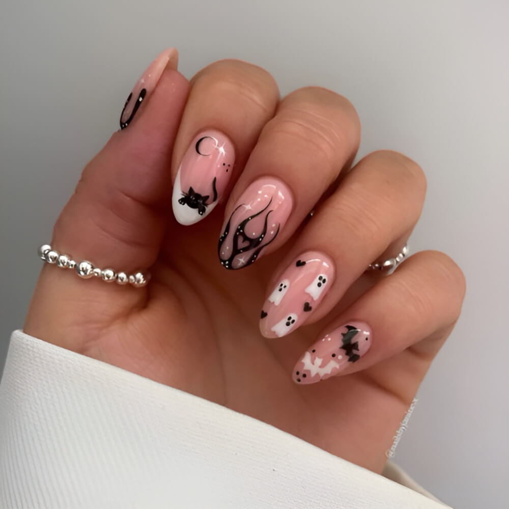 Black and white Halloween nails with ghost and flame design – bold and spooky nail art.