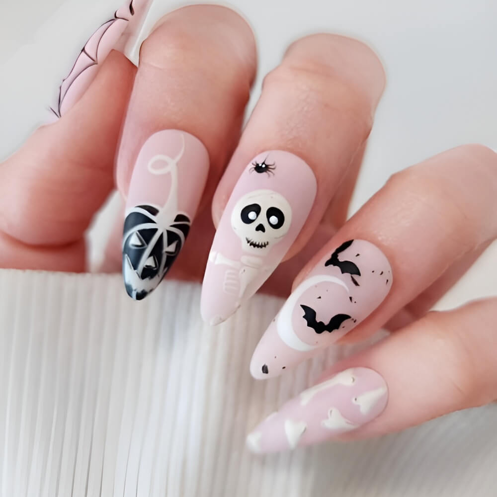 Black and white Halloween nails featuring spooky characters – perfect for creepy-cute nail lovers.