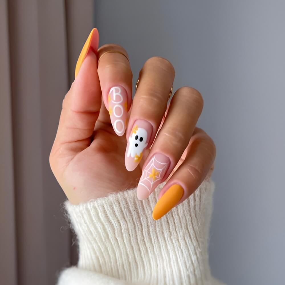 Halloween nails with “boo” lettering and cute ghosts in orange and white – fun spooky nail art. Beautiful Halloween nails ideas