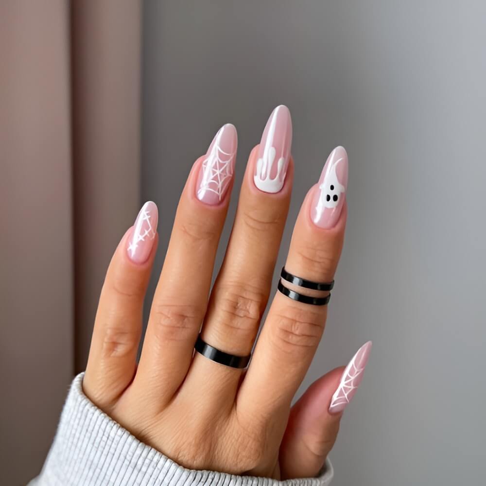 Minimalist white Halloween nails with subtle spooky touches – simple and classy nail design.