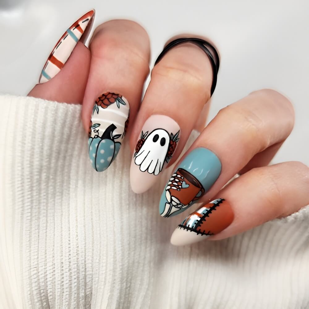 Country western Halloween nails with cow print and pumpkin accents – unique Halloween nail design.