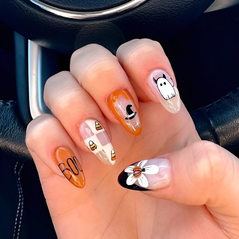 Halloween nails with floral design and “boo” lettering – pretty and spooky nail art combo.