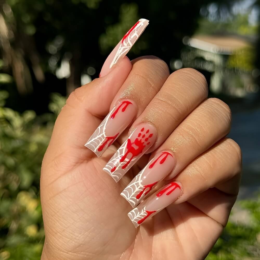 French tip Halloween nails with spider web design and bloody hand accents