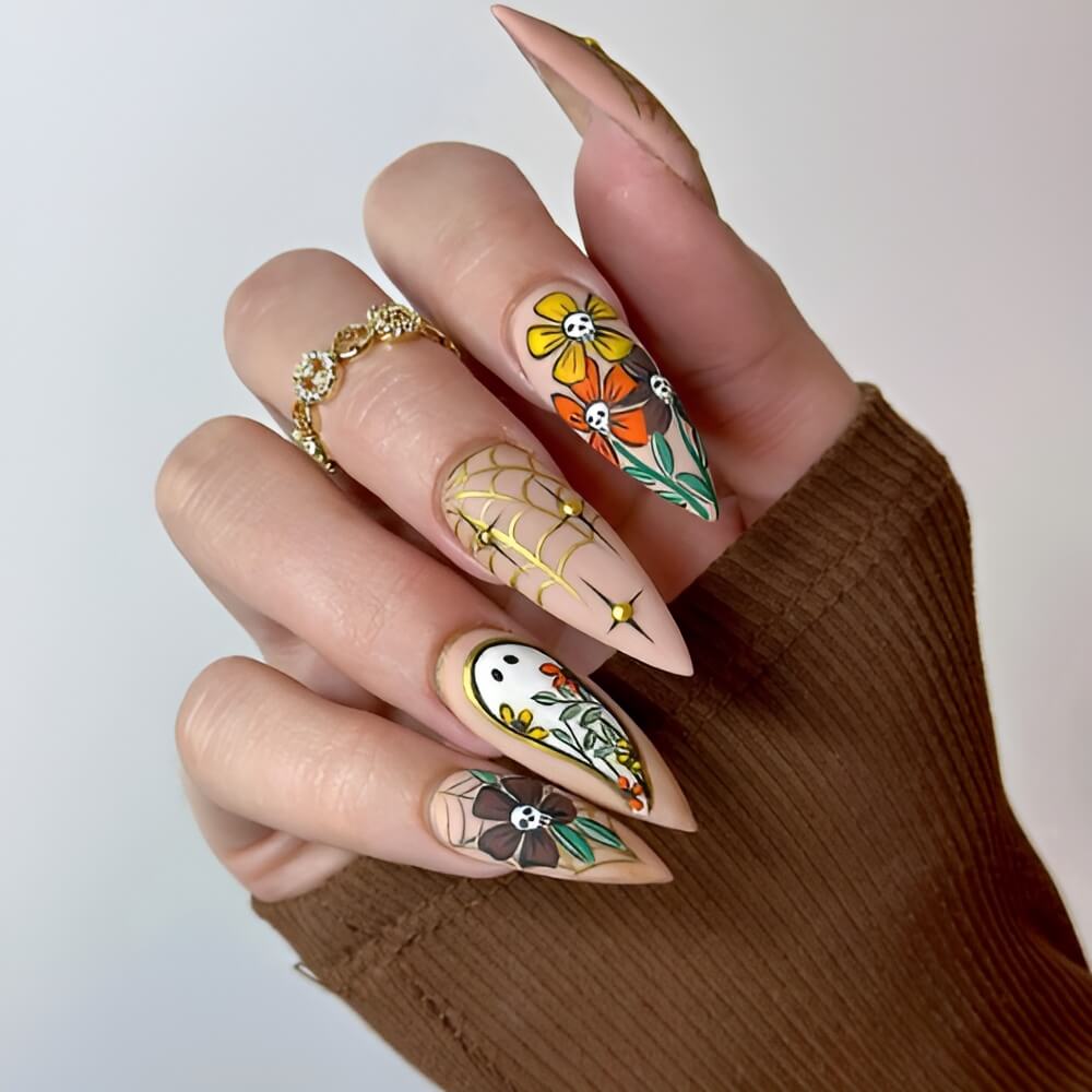 Gold Halloween nails with flower accents – elegant spooky nail idea for Halloween.