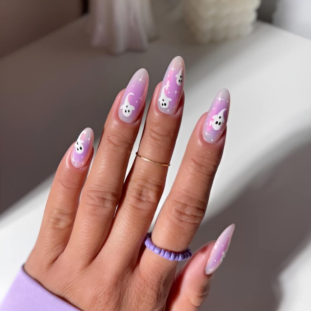 Light purple Halloween nails with ghost design – cute pastel ghost nail art.