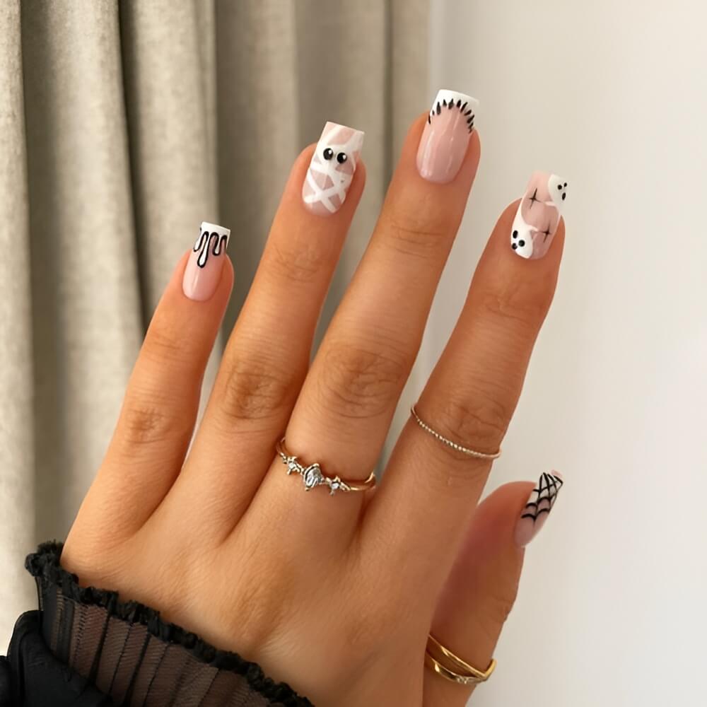 White Halloween nails with mummy face design – cute and spooky mummy nail art. Beautiful Halloween nails ideas