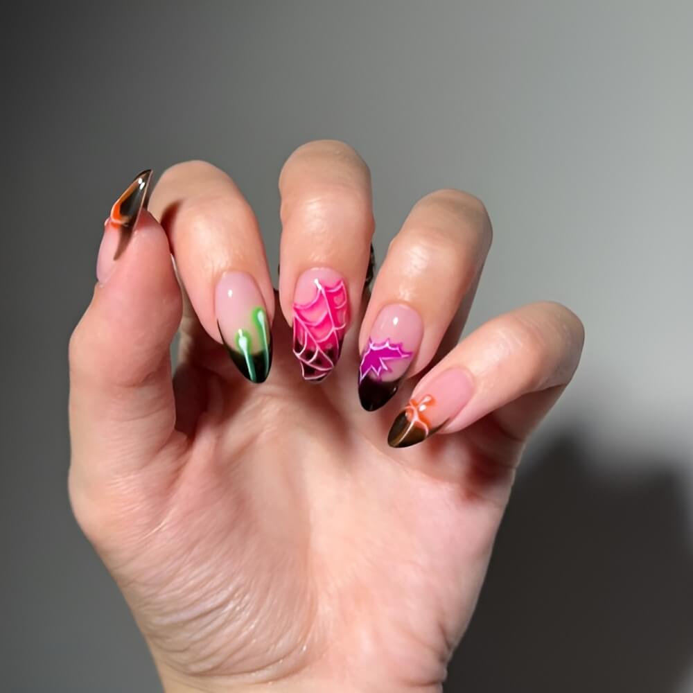 Neon spiderweb Halloween nails with black French tips – edgy and glowing spooky nail look.