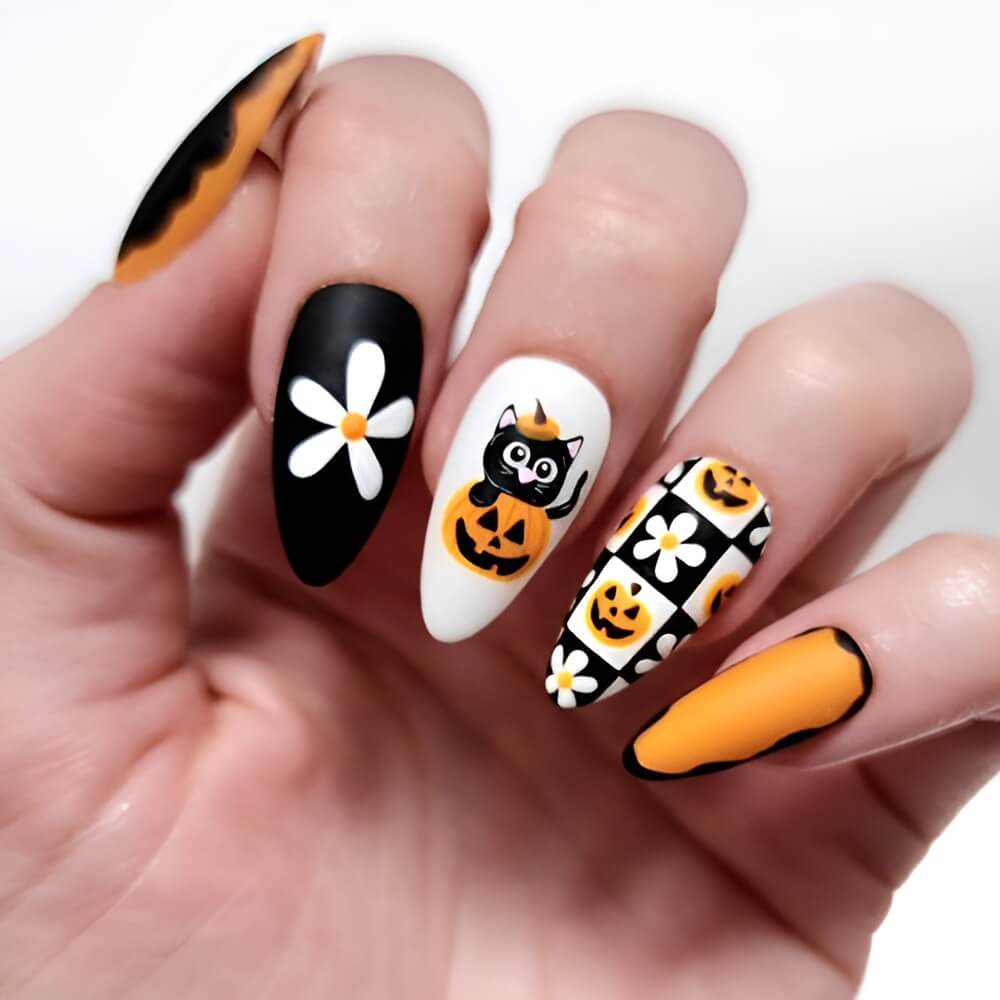 Cute Halloween nails with black and orange floral design and a cat popping out of a pumpkin.