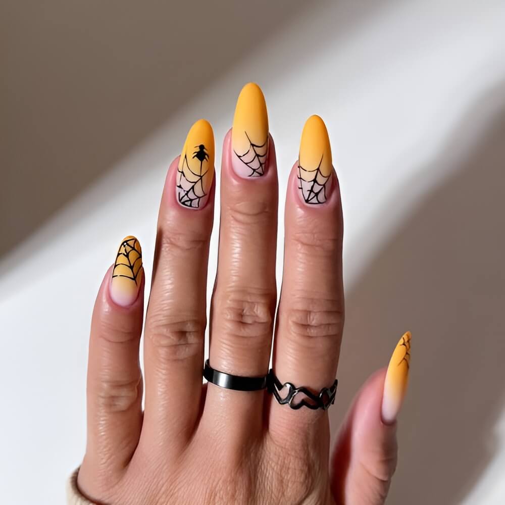 Orange Halloween nails with black spiderweb tips – creepy chic spooky nail idea. Beautiful Halloween nails ideas