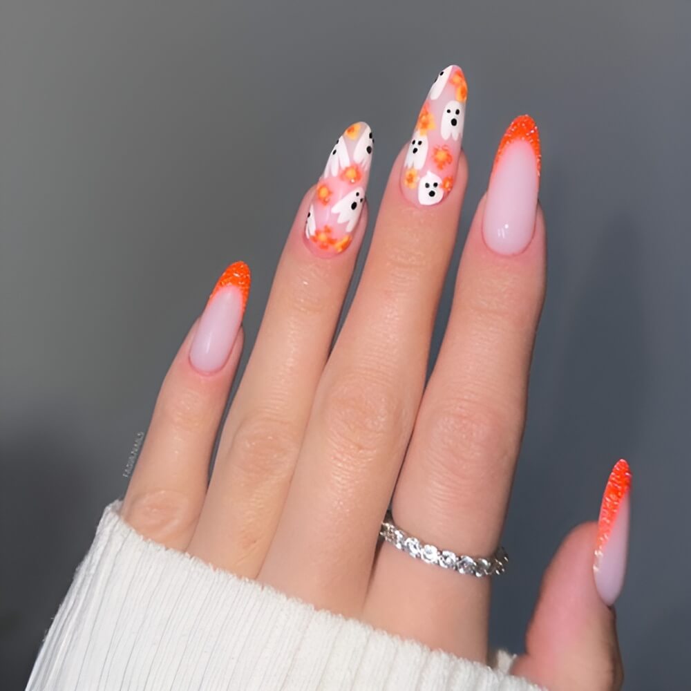 Orange French tip Halloween nails with floating ghosts – playful and spooky nail design.