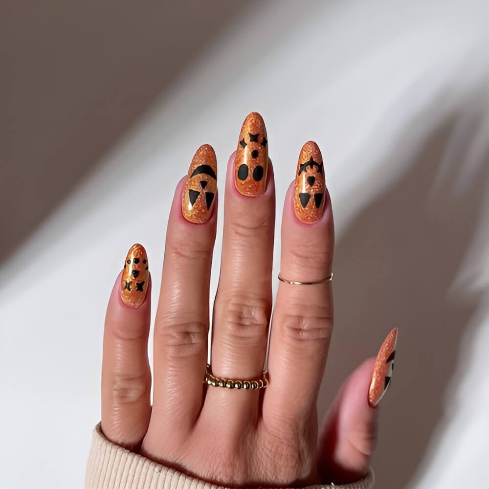 Halloween nails with jack-o’-lantern pumpkin carving art – festive nail idea for spooky season. Beautiful Halloween nails ideas