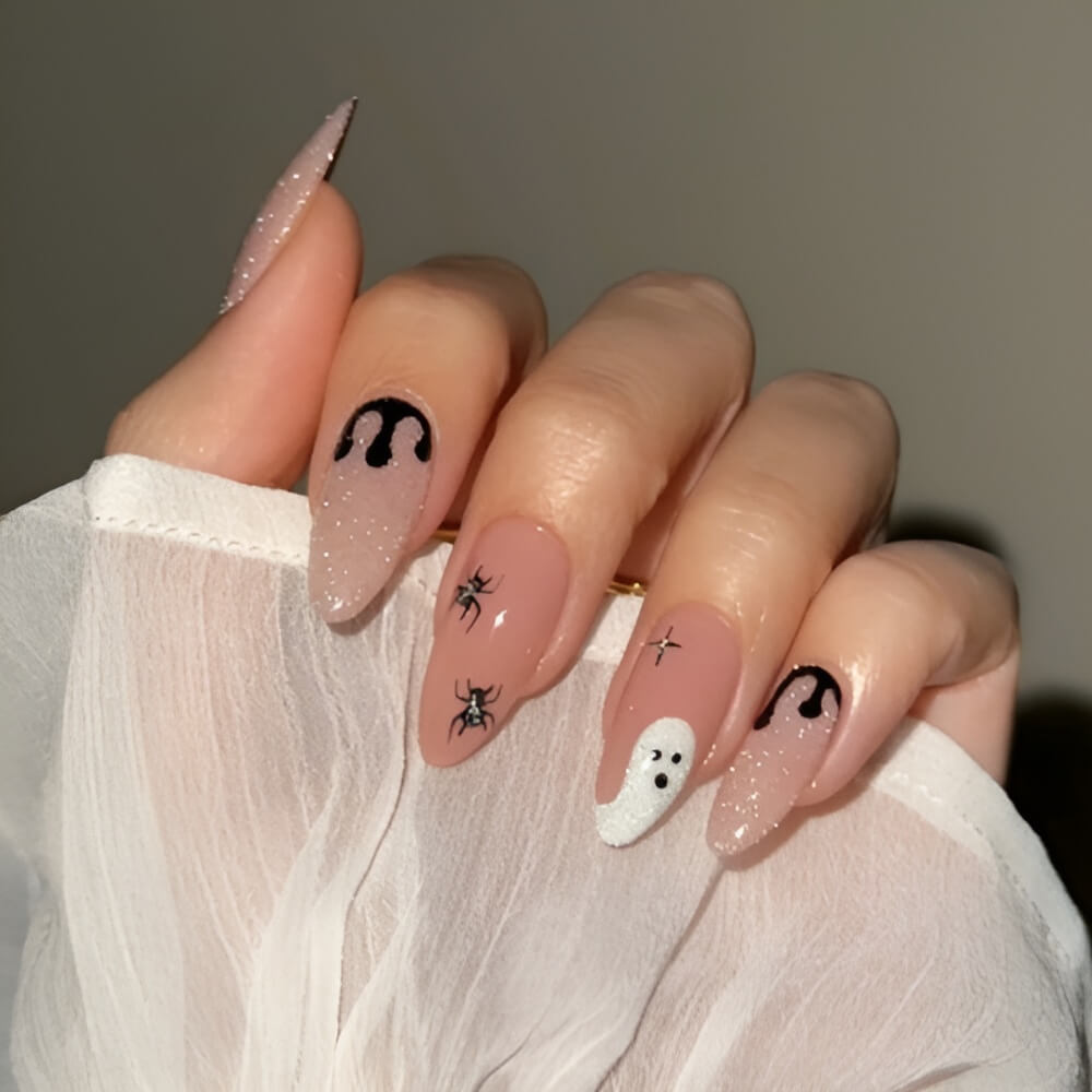 Elegant crystal clear nails with simple ghost and spider Halloween accents. Beautiful Halloween nails ideas
