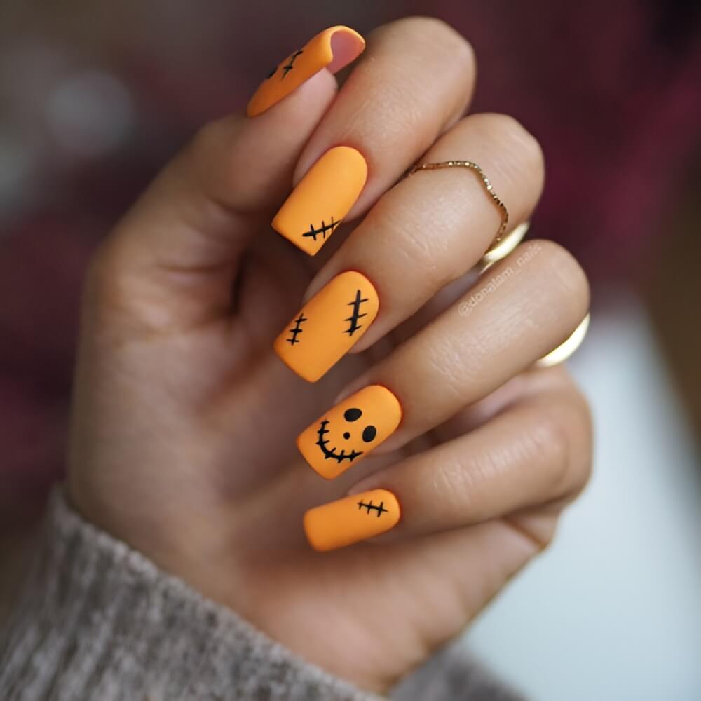 Simple solid orange Halloween nails – classic and bold spooky nail look.