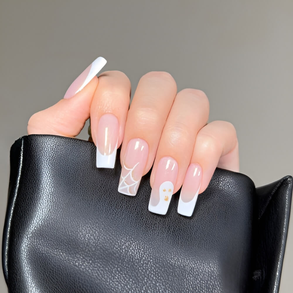 Simple white French Halloween nails with cute ghost accent – perfect minimalist spooky nail art.