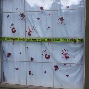 Fake bloody handprints on windows for scary Halloween horror movie-inspired home decoration. Halloween Decor