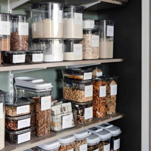 Clear stackable containers filled with pasta and flour for small pantry organization