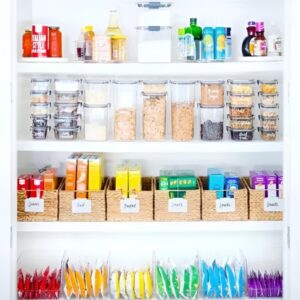 Color-coded baskets and labels organizing pantry by category. Small pantry organization