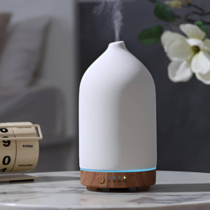 Essential oil diffuser on a desk bringing relaxing lavender or eucalyptus scents.