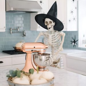 Life-size skeletons doing daily activities like drinking and lounging for humorous Halloween decoration. Halloween Decor