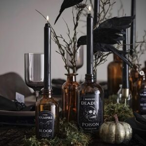 Gothic-style black candles and blood-drip effects arranged for creepy Halloween home decor. Halloween Decor