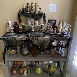 DIY potion bottle display with spooky labels and colored liquid for witch-themed Halloween decor