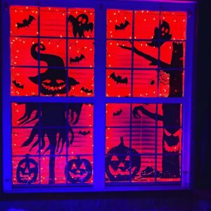 DIY spooky Halloween window silhouettes with glowing backlights for festive outdoor decor. Halloween Decor