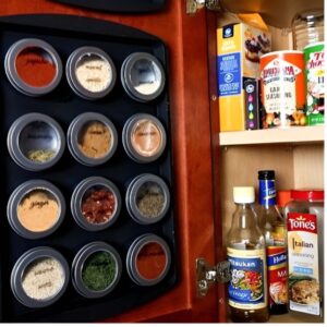 Magnetic spice jars on pantry wall saving space in a small kitchen. Small pantry organization