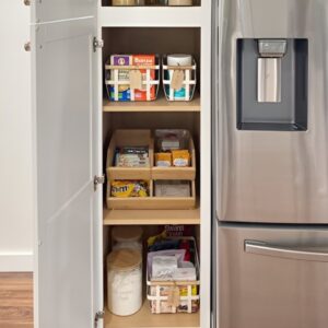 Stackable clear storage bins organizing snacks and baking ingredients. Small pantry organization