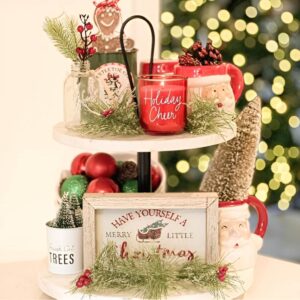 Festive Christmas-themed kitchen countertop decor with candles, ornaments, and holiday greenery.