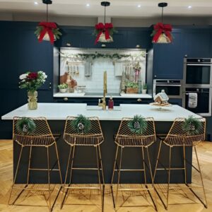 Christmas ribbon bows tied on cabinets and jars for simple and festive kitchen decor.