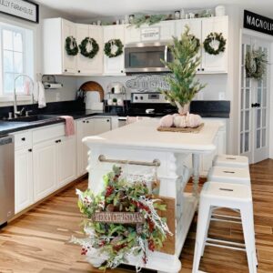 Christmas wreath hanging on pantry door adding holiday charm to the kitchen decor. Christmas Kitchen Decoration