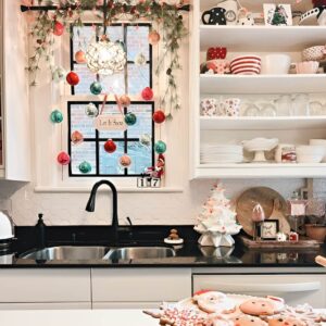 Hanging ornaments on kitchen cabinets and shelves for a sparkling Christmas decor look.