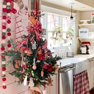 Mini Christmas tree on a kitchen counter with lights and ornaments for a festive holiday touch. Christmas Kitchen Decoration
