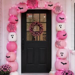 Pink Halloween pumpkin arch decorating a front door for spooky season