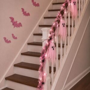 Staircase decorated with pastel bats and a spooky garland