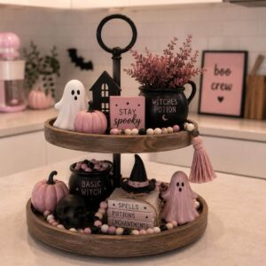 Pink Halloween tiered tray filled with cute miniature spooky decorations